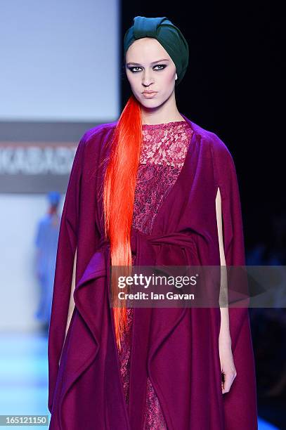 Model walks the runway at the Goga Nikabadze show during Mercedes-Benz Fashion Week Russia Fall/Winter 2013/2014 at Manege on March 31, 2013 in...