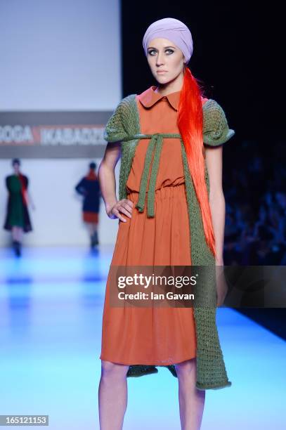 Model walks the runway at the Goga Nikabadze show during Mercedes-Benz Fashion Week Russia Fall/Winter 2013/2014 at Manege on March 31, 2013 in...