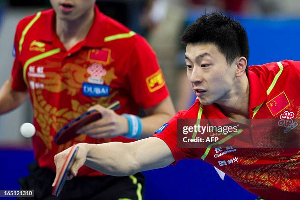 Ma Long of China and his teammate returns against Jung Youngsik of Chinese Taipei and his teammate in the finals at the World Team Classic Table...