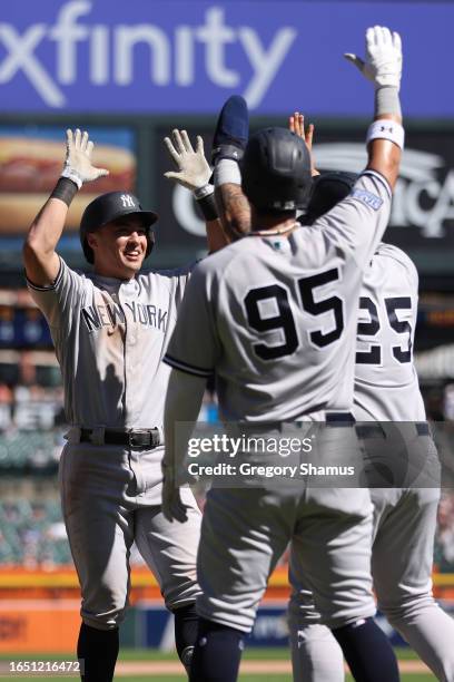 Anthony Volpe of the New York Yankees celebrates his three run home run in the ninth inning with Oswaldo Cabrera and Gleyber Torres while playing the...