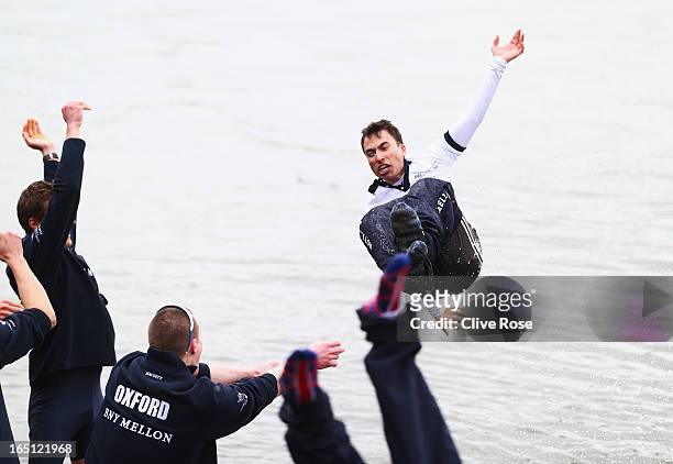 Oskar Zorrilla of Oxford, the winning cox is thrown into the River Thames after the BNY Mellon 159th Oxford versus Cambridge University Boat Race on...