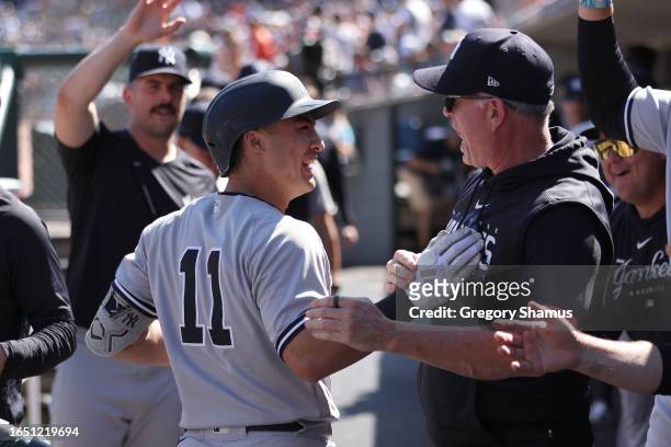 Anthony Volpe of the New York Yankees celebrates his three run ninth inning home run with teammates while playing the Detroit Tigers at Comerica Park...