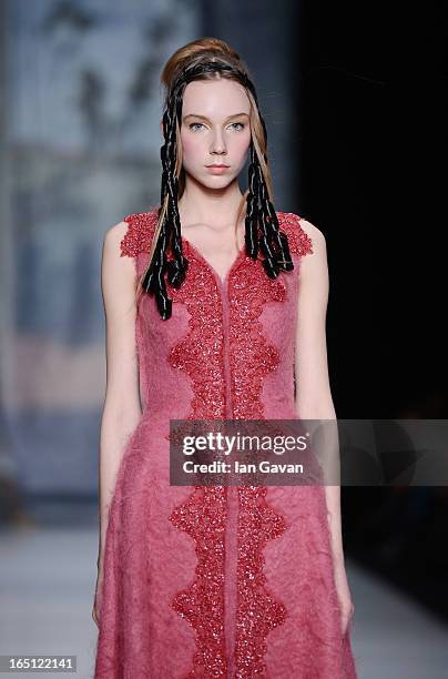 Model walks the runway at the Tatyana Parfionova show during Mercedes-Benz Fashion Week Russia Fall/Winter 2013/2014 at Manege on March 31, 2013 in...