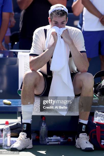 John Isner of the United States reacts to a final career match loss against Michael Mmoh of the United States during their Men's Singles Second Round...