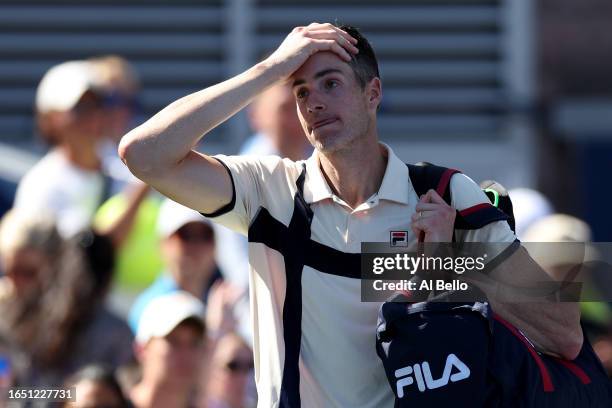 John Isner of the United States reacts to a final career match loss against Michael Mmoh of the United States during their Men's Singles Second Round...