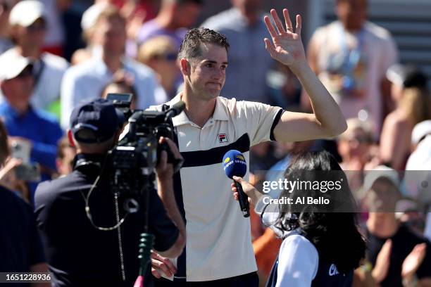John Isner of the United States waves to the crowd after a final career match loss against Michael Mmoh of the United States during their Men's...