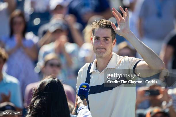 August 31: A distraught John Isner of the United States during his on-court interview after his five-set tie break loss to Michael Mmoh of the United...