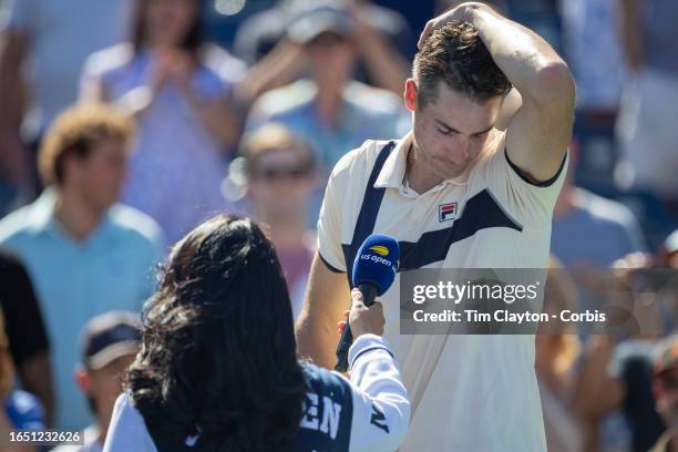 August 31: A distraught John Isner of the United States during his on-court interview after his five-set tie break loss to Michael Mmoh of the United...