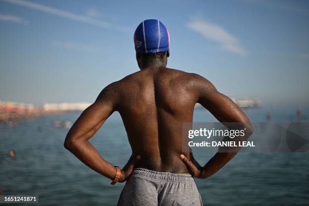 Beachgoer prepares to leap into the sea at Brighton, on the south coast of England on September 7 as the late summer heatwave continues.