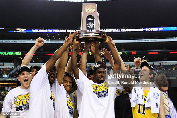 Tim Hardaway Jr. #10 of the Michigan Wolverines and teammate celebrate their 79 to 59 win ovewr the Florida Gators during the South Regional Round...