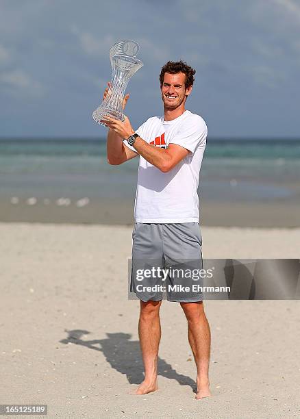 Andy Murray of Great Brittain poses on the beach at Key Biscayne after winning the final of the Sony Open against David Ferrer of Spain at Crandon...