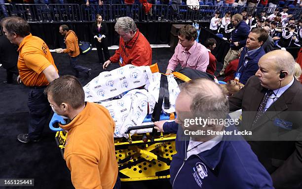 Kevin Ware of the Louisville Cardinals is taken off the court on a backboard after he injured his leg in the first half against the Duke Blue Devils...