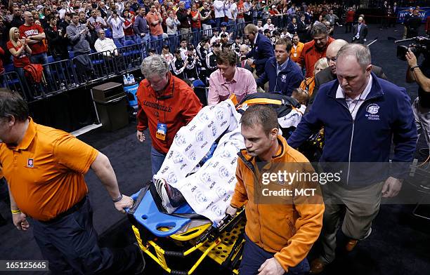 Louisville guard Kevin Ware is taken from the floor after breaking his leg in first half action in the NCAA regional final game on Sunday, March 31...