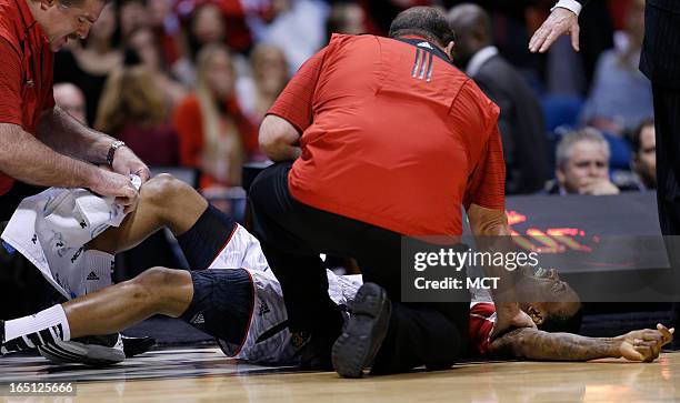 Louisville guard Kevin Ware screams in pain after breaking his right leg in first half action in the NCAA regional final game on Sunday, March 31 in...