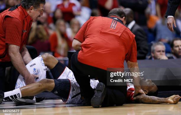 Louisville guard Kevin Ware screams in pain after breaking his right leg in first half action in the NCAA regional final game on Sunday, March 31 in...