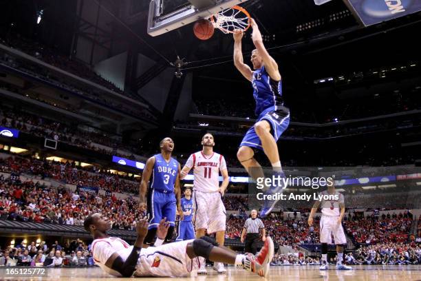 Mason Plumlee of the Duke Blue Devils dunks in the second half over Gorgui Dieng of the Louisville Cardinals during the Midwest Regional Final round...