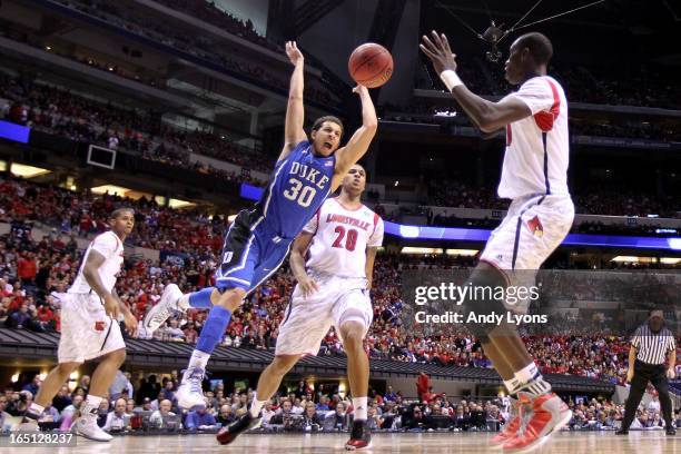 Seth Curry of the Duke Blue Devils loses the ball as he drives in the second half past Wayne Blackshear of the Louisville Cardinals during the...