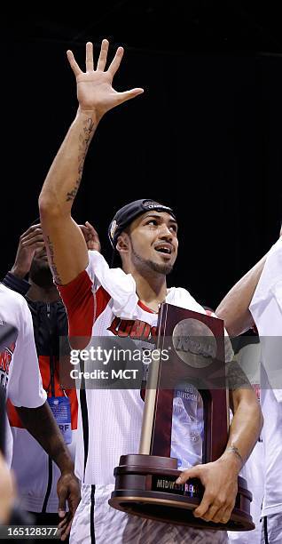 Louisville guard Peyton Siva honors teammate Louisville guard Kevin Ware after the game as Ware broke his leg in first half action in the NCAA...