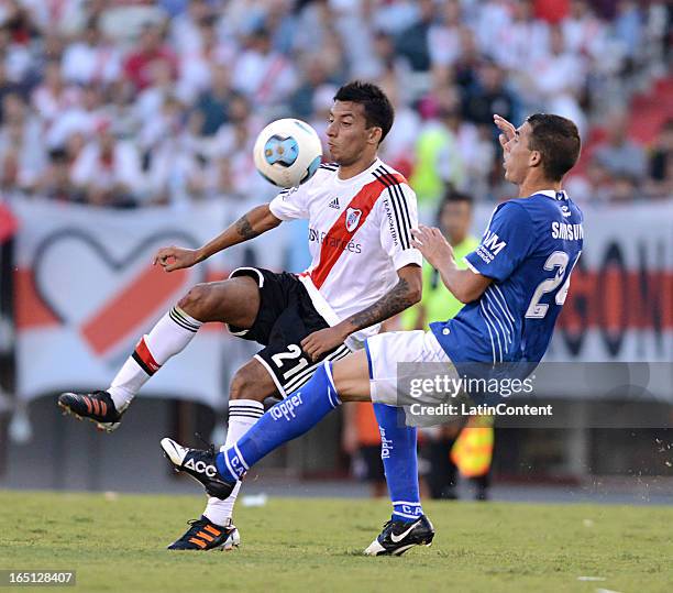 Leonel Vangioni, left, of River Plate struggles for the ball with Ivan Bella, right, of Velez Sarsfield during a match between River Plate and Velez...