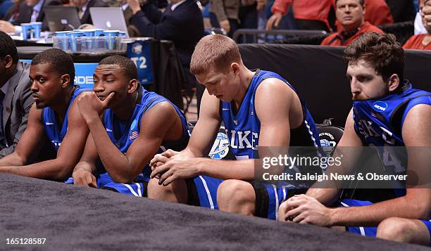 Duke players, left to right, guard Tyler Thornton , guard Rasheed Sulaimon , forward Mason Plumlee and forward Ryan Kelly sit as time runs out during...