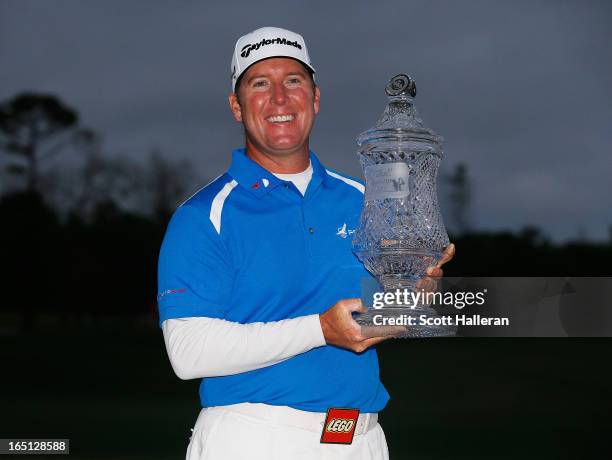 Points poses with the trophy on the 18th green after winning the Shell Houston Open at the Redstone Golf Club on March 31, 2013 in Humble, Texas.