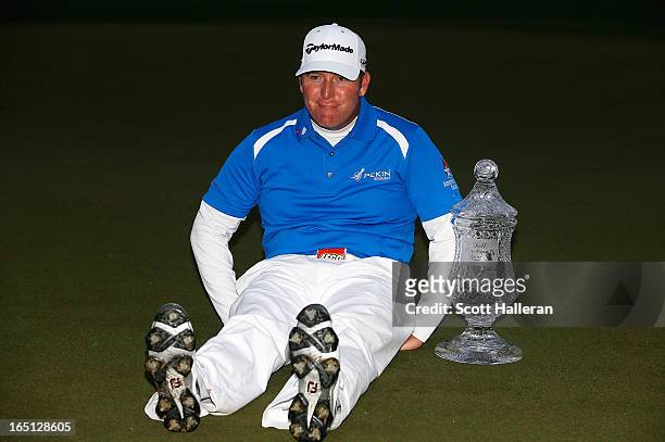 Points strikes a "Dufnering" pose with the trophy on the 18th green after winning the Shell Houston Open at the Redstone Golf Club on March 31, 2013...