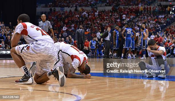 Louisville players collapse on the floor after teammate guard Kevin Ware broke his leg in the first half of the NCAA Tournament at Lucas Oil Stadium...