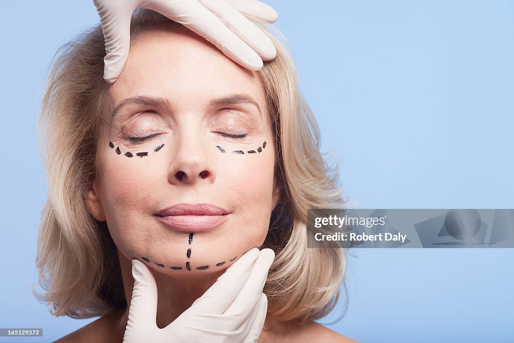 Close up portrait of woman with dotted lines on face