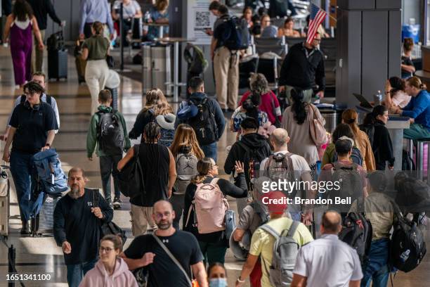 People travel through the Austin-Bergstrom International Airport on August 31, 2023 in Austin, Texas. The FAA has projected Thursday to be the...
