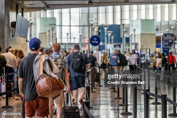 Passengers wait to pass through security at the Austin-Bergstrom International Airport on August 31, 2023 in Austin, Texas. The FAA has projected...