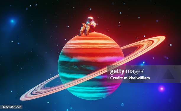 astronauta solitario se sienta en un pequeño planeta colorido en medio del espacio - astronaut sitting in spaceship fotografías e imágenes de stock