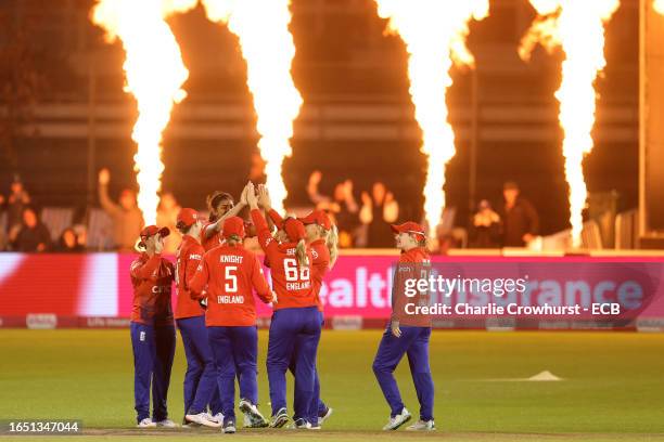 Mahika Gaur of England celebrates with team mates after taking the wicket of Sri Lanka's Chamari Athapaththu during the 1st Vitality IT20 between...