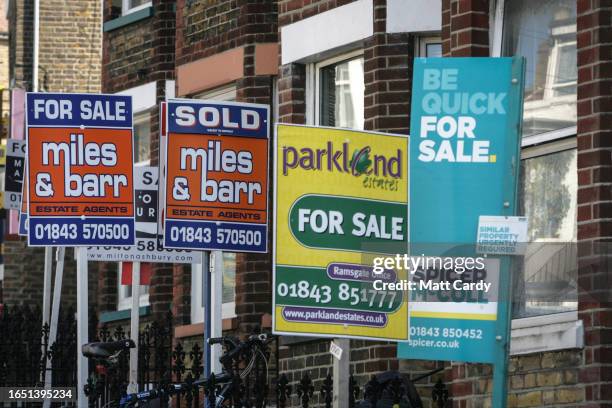 Estate agent for sale boards are seen outside a block of flats, on May 11, 2008 in Bristol, England. According to a report from the Royal Institution...