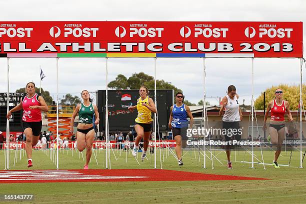 Davina Strauss crosses the line to win in the State of Victoria Strickland Family Women's Gift 120m Semi Final 3 during the 2013 Stawell Gift...