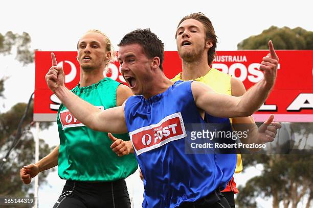 Andrew Robinson of Tasmania celebrates as he crosses the line to win the Australia Post Stawell Gift 120m Final during the 2013 Stawell Gift carnival...