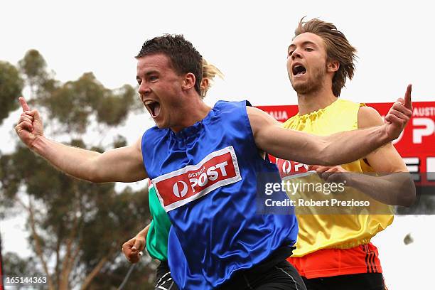 Andrew Robinson of Tasmania celebrates as he crosses the line to win the Australia Post Stawell Gift 120m Final during the 2013 Stawell Gift carnival...