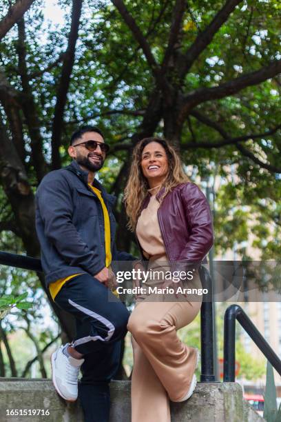 latino brothers are together in the street walking feeling comfortable and calm with a good expression on their face - mario bros stock pictures, royalty-free photos & images