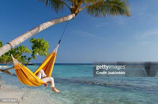 hammock relaxation by the sea - beach hammock stock pictures, royalty-free photos & images