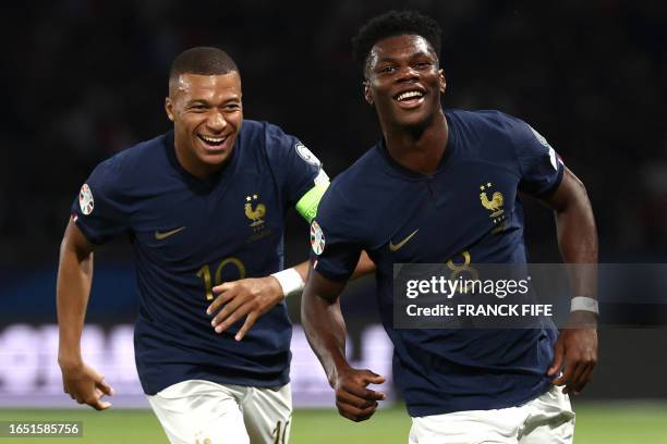 France's midfielder Aurelien Tchouameni celebrates with France's forward Kylian Mbappe after scoring his team's first goal during the UEFA Euro 2024...