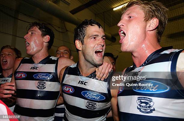 Mark Blicavs, Jared Rivers and Josh Caddy of the Cats celebrate in the rooms after winning the round one AFL match between the Hawthorn Hawks and the...