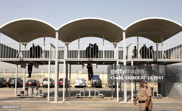 Three men hang from the gallows being executed by hanging just west of the capital Kuwait City on April 1,2013. Authorities in Kuwait hanged three...