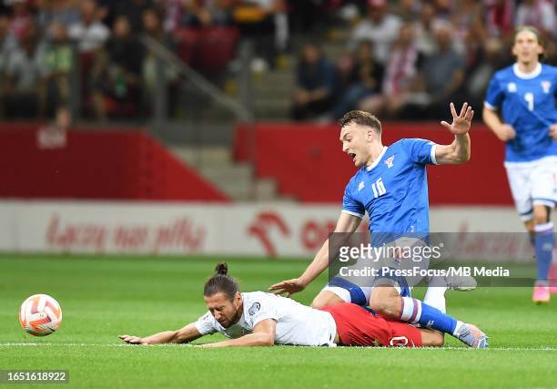 Grzegorz Krychowiak of Poland and Gunnar Vatnhamar of Faroe Islands compete for the ball during the UEFA EURO 2024 European qualifier match between...