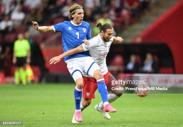 Joannes Bjartalio of Faroe Islands tackles Grzegorz Krychowiak of Poland during the UEFA EURO 2024 European qualifier match between Poland and Faroe...