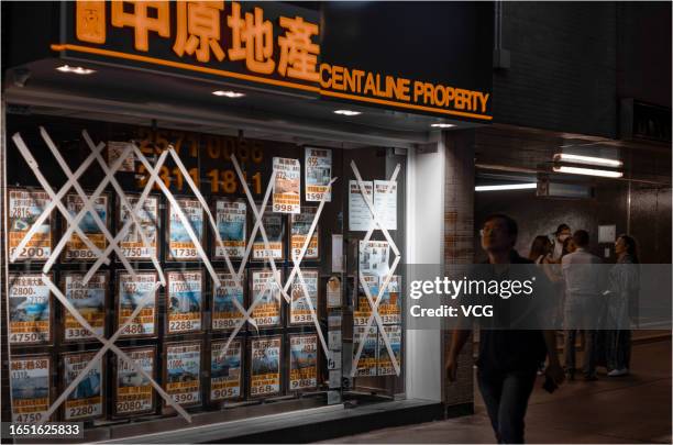 The windows of a store are protected with tape against strong winds before the arrival of typhoon Saola on August 31, 2023 in Hong Kong, China.