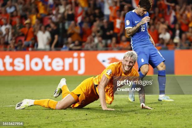 Wout Weghorst of Holland celebrates the 3-0, Lazaros Rota of Greece is disappointed during the European Championship Qualifying match in group B...