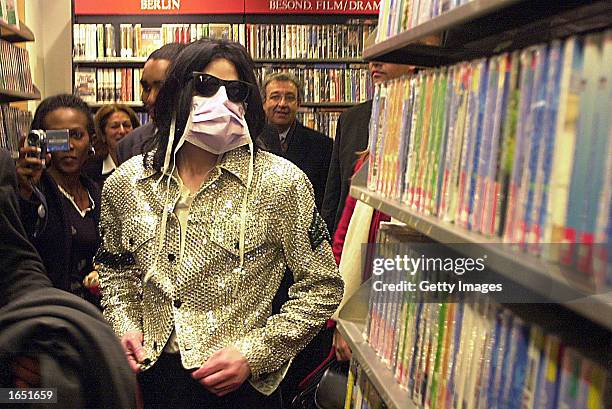 Singer Michael Jackson shops at the Dusmann Cultural mega-store November 19, 2002 in Berlin. Jackson is in Berlin with his three children to accept a...