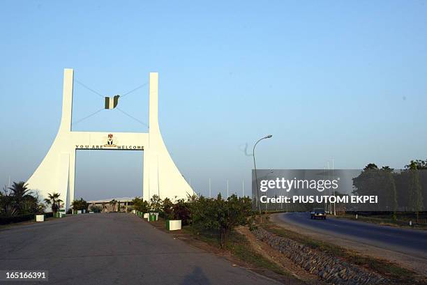 Car drives past the city gate to Abuja, Nigeria's federal capital territory, 27 November 2006. Nigeria's federal capital, which is poised to host an...