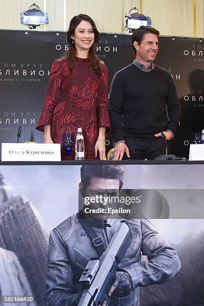 Olga Kurylenko and Tom Cruise attend a photo call of the 'Oblivion' at the Ritz Carlton Hotel on April 1, 2013 in Moscow, Russia.