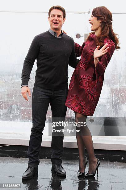 Olga Kurylenko and Tom Cruise attend a photo call of the 'Oblivion' at the Ritz Carlton Hotel on April 1, 2013 in Moscow, Russia.