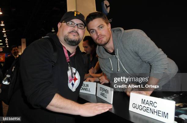 Actor Stephen Amell of The WB's "Arrow" signs autographs at the DC Comics booth at WonderCon Anaheim 2013 - Day 3 held at Anaheim Convention Center...